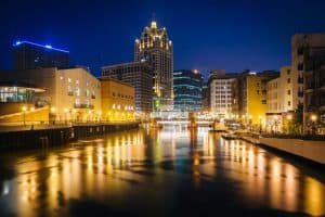 Image of buildings along a river at night in Wisconsin