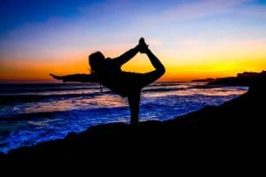 Image of a person doing yoga on the beach near San Jose, CA