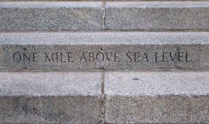 Image of a stone carving in Denver that shows the elevation of one mile above sea level