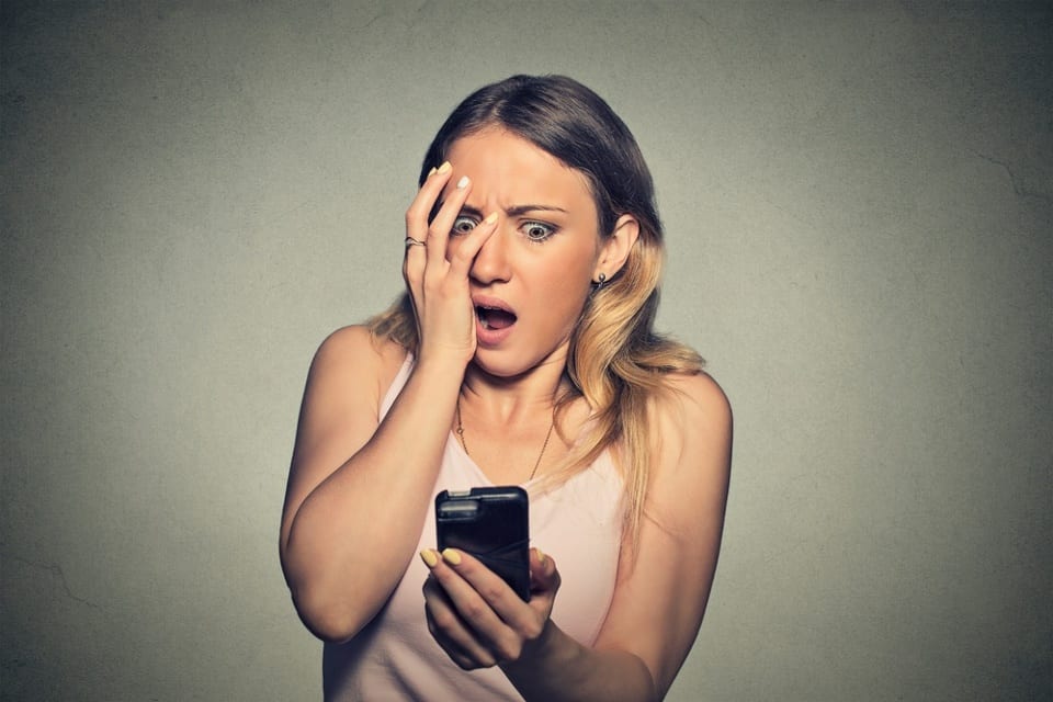 Image of a business woman going through the phone stages of grief