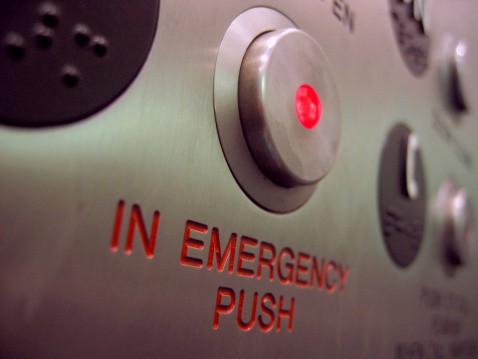 Image of an emergency call button in an elevator that connects people with an elevator answering service