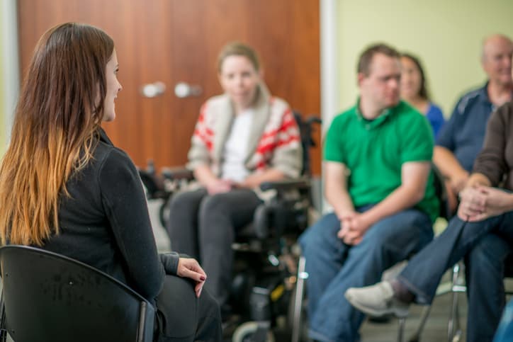 Image of a group meeting supported by an addiction recovery answering service