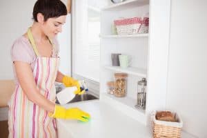 Image of a woman cleaning a house as part of her home-based business
