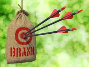 Image of a branded target and three arrows representing an answering service for franchises staying on brand