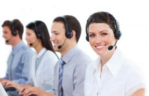 Image of four receptionists working at a higher education call center