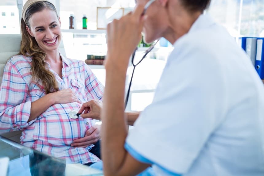 Image of a pregnant woman being examined by her doctor who uses an OBGYN answering service