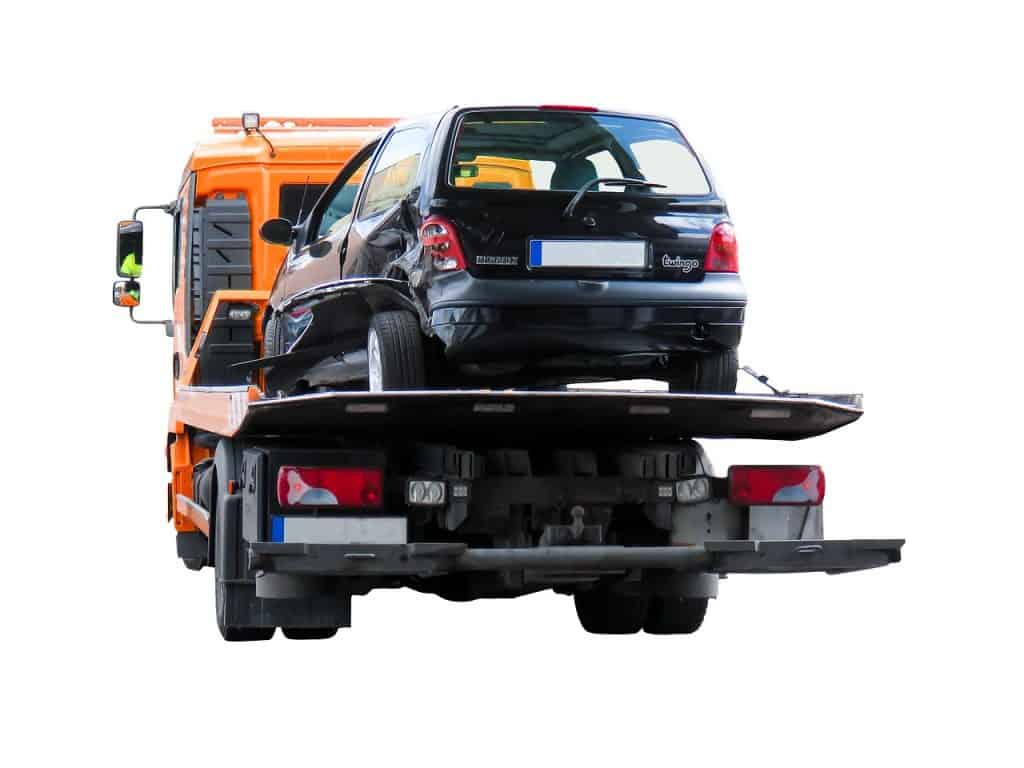 Image of a tow truck with a car on a flatbed