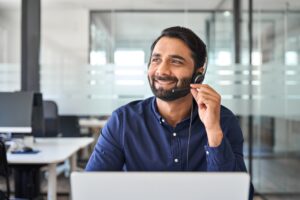 man wearing a call center headset and smiling on the job