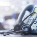 image of a telephone and headset on a desk